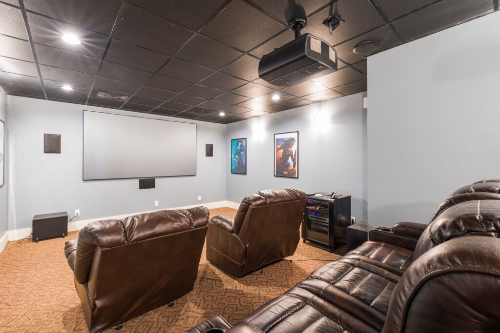 Dedicated home theater room with a projector screen and leather recliner seating in a Harford County, Maryland home