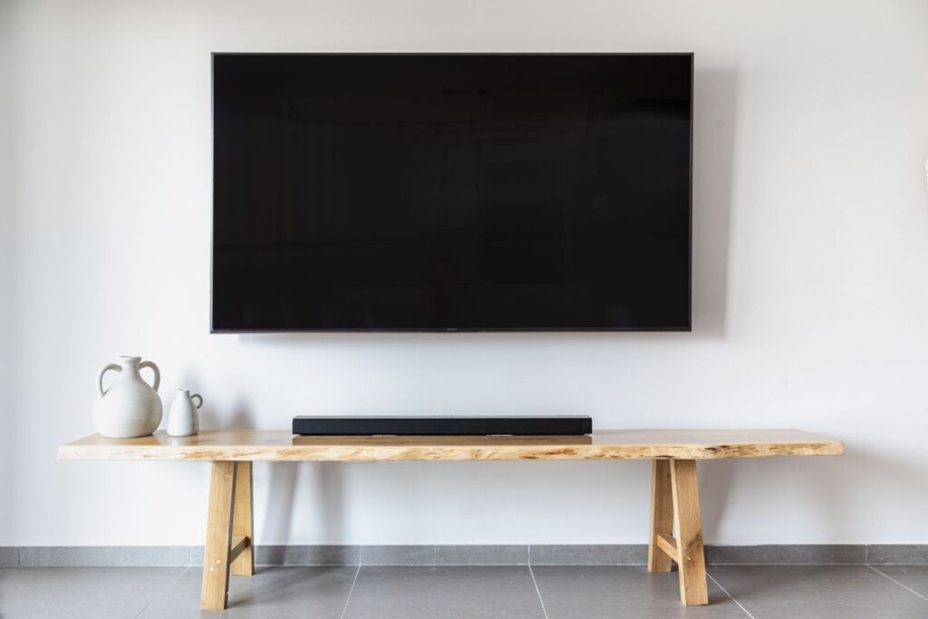 Flat-screen TV professionally wall-mounted with clean cable management above a console in an Aberdeen and Bel Air area living room